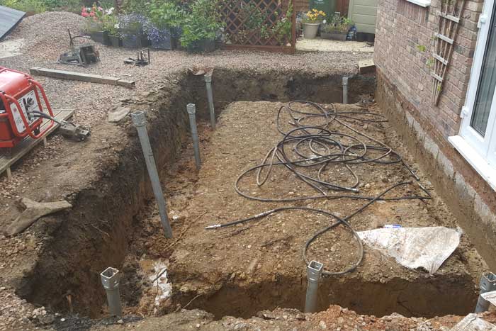 Groundworks trench with footings and ducting before the slab